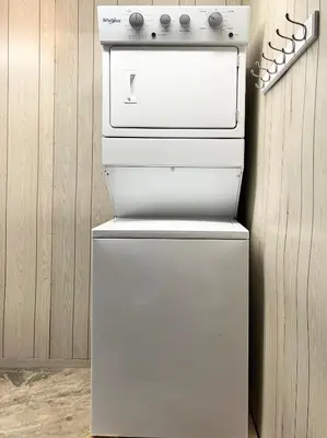 a white stove in a kitchen next to a wall at The McCleery Inn in Vancouver