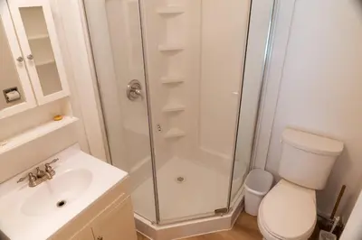 a bathroom with a shower and a toilet and a sink at Little Beach Resort in Ucluelet