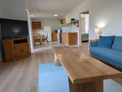 a living room with a blue couch and a table at Little Beach Resort in Ucluelet