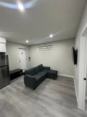 a living room with a couch and a tv at Beautiful 2 bedroom 2 bath in NW Calgary in Calgary