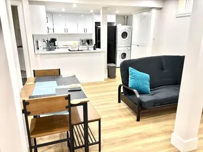 a living room with a couch and a table at Valley Home 2 Bed 1 Bath Walkout Basement Apartment, 1hr to Banff, 40 Mins Canmore, 5 mins to WinSport & Olympic park in Calgary