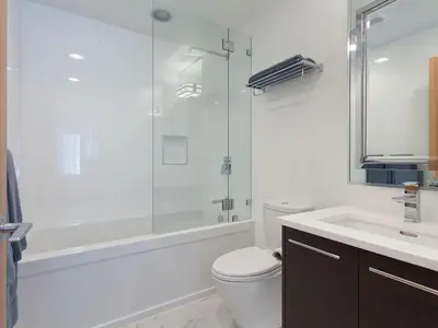 a bathroom with a toilet and a shower and a sink at Tyndall Stone 317 by Outpost Whistler in Whistler