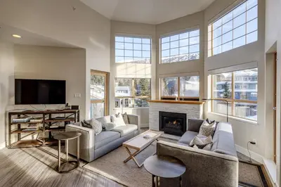a living room with a couch and a fireplace at Tyndall Stone 317 by Outpost Whistler in Whistler