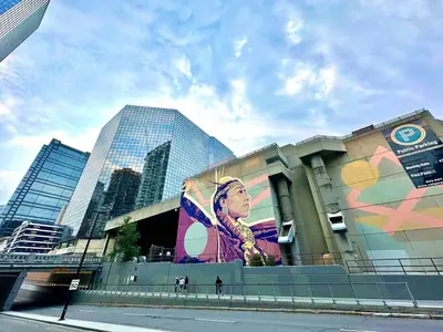a building with a large mural on the side of it at MicroNest - Modern Overlooking Downtown Parking in Calgary
