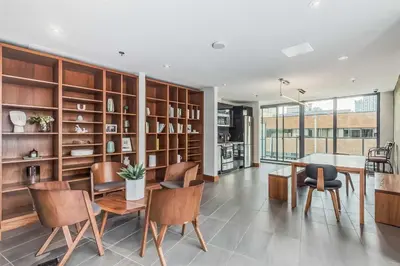 a dining room with wooden shelves and a table and chairs at MicroNest - Modern Overlooking Downtown Parking in Calgary