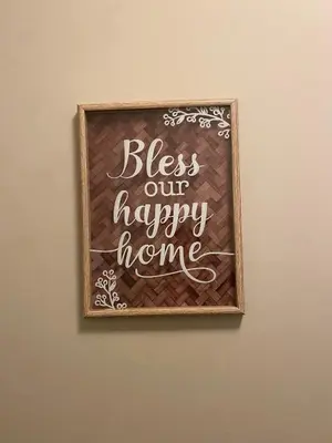 a chalkboard with a sign that reads bless our happy home at Mahogany's Comfy Haven in Calgary