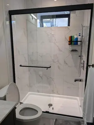 a bathroom with a shower and a toilet at Delux 2 bedroom suite in White Rock