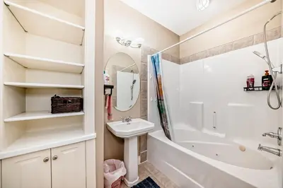 a bathroom with a sink and a tub and a toilet at cozy two bedrooms with external bathroom just for you in Calgary