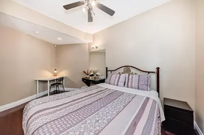 a bedroom with a bed and a ceiling fan at cozy two bedrooms with external bathroom just for you in Calgary