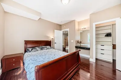 a bedroom with a large bed and a bathroom at cozy two bedrooms with external bathroom just for you in Calgary