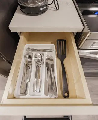 a drawer with utensils on a cutting board at Dumfries Guest Room in Vancouver in Vancouver