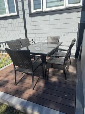 a glass table and chairs on a wooden deck at Dumfries Guest Room in Vancouver in Vancouver