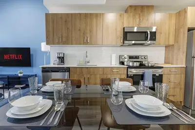 a kitchen with a table with plates and glasses on it at DT Edmonton King Suite with Parking & 100 Walk Score in Edmonton