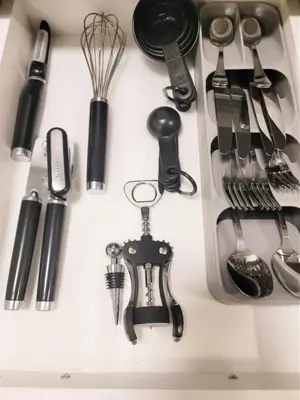 a bunch of kitchen utensils on a shelf at Lovely Modern 2 Bedroom Basement Suite in Edmonton