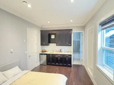a kitchen with black cabinets and a counter top at Kane Jolly Lodge in Richmond