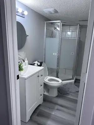 a bathroom with a shower and a toilet and a sink at Valley Gateway in Calgary