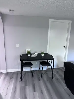 a black table and two chairs in a room at Valley Gateway in Calgary