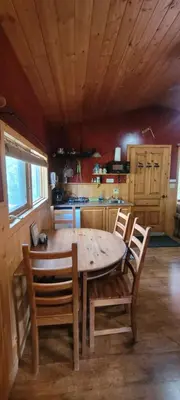 a wooden table and chairs in a kitchen at Beautiful Cabin near Radium Hot Springs with private hot tub in Radium Hot Springs