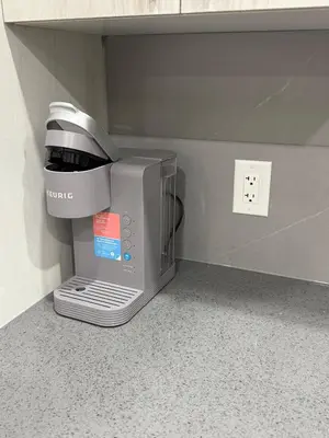 a microwave oven sitting on the floor in a room at Luxe Stay with a Designer Touch in Calgary