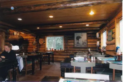 a man sitting at a table in a restaurant at Tatogga Lake Resort in Iskut