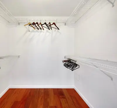 a room with white walls and wooden floors at Luxury 2BR Designer Apartment In The Heart Of Downtown! in Vancouver