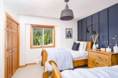 a bedroom with two beds and a window at Perfection South 1 in Big White