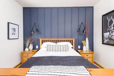 a bedroom with a large bed with blue walls at Perfection South 1 in Big White