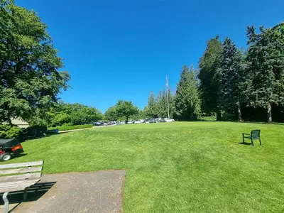 a park with two park benches in the grass at Cozoro 3 BEDROOMS Centre Vancouver in Vancouver