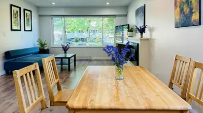 a living room with a table with a vase of flowers on it at Cozoro 3 BEDROOMS Centre Vancouver in Vancouver