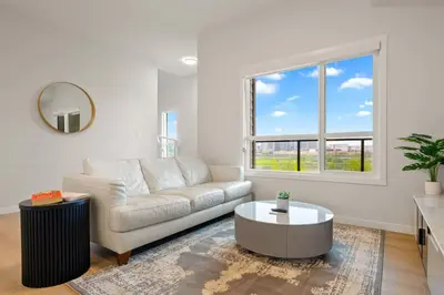 a living room with a couch and a table at 3 Bedroom Luxurious Seton Town Home with Central AC and Lake View in Calgary