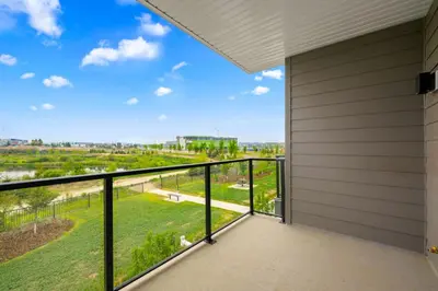 a balcony with a view at 3 Bedroom Luxurious Seton Town Home with Central AC and Lake View in Calgary