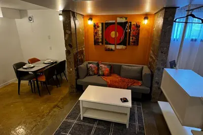 a living room with a couch and a table at Main Street Suites Nanton in Nanton