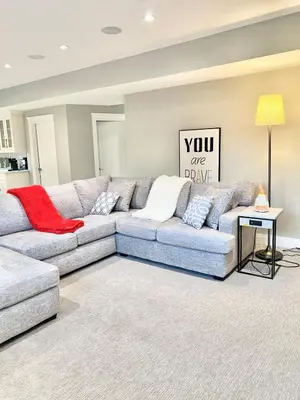 a living room with a couch and a table at Luxury Chestermere Retreat in Calgary