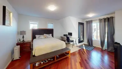 a bedroom with a bed and a desk in it at Cozy comfy and relaxing home at Cougaridge SW Calgary in Calgary