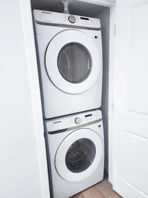 a washer and dryer in a small room at Cozy 2 BR Suite Self check-in I Free Park Pass in Calgary