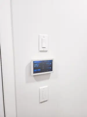 a television mounted on a wall with switches at Cozy 2 BR Suite Self check-in I Free Park Pass in Calgary