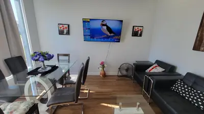 a living room with a couch and a glass table at 3 Bedroom House Near Airport and Downtown in Calgary