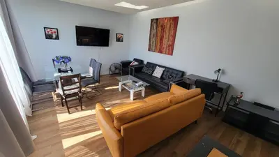 a living room with a couch and a table at 3 Bedroom House Near Airport and Downtown in Calgary