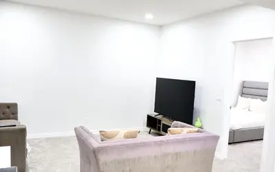 a living room with a couch and a flat screen tv at Apartment In Calgary Near Airport in Calgary