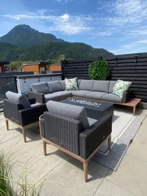 a patio with couches and a table and chairs at Stylish Three Bedroom Townhome in Squamish