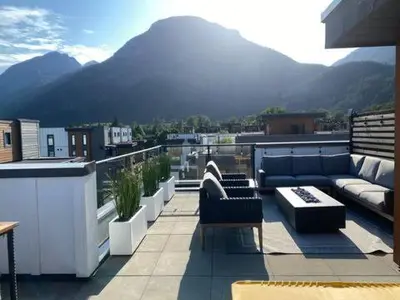 a balcony with couches and a view of a mountain at Stylish Three Bedroom Townhome in Squamish