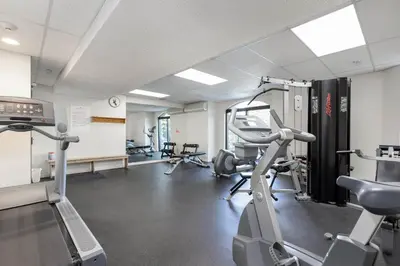 a gym with treadmills and ellipticals in a room at 1BR and Sofabed in Marquise, Near Ski Hill, Fireplace, Hot Tub and Sauna, Gym Access in Whistler
