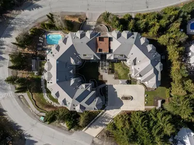 an aerial view of a mansion with a swimming pool at 1BR and Sofabed in Marquise, Near Ski Hill, Fireplace, Hot Tub and Sauna, Gym Access in Whistler