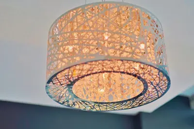 a glass chandelier hanging from a ceiling at Urbanest - Spectacular Views & Amenities Parking in Calgary