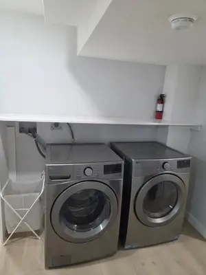 a washer and dryer in a small room at Exclusive Suite in Edmonton in Edmonton