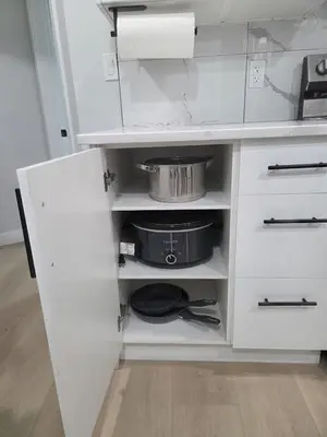 a kitchen with white cabinets and a pot and pans at Exclusive Suite in Edmonton in Edmonton