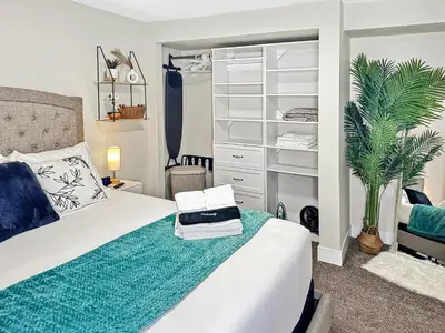 a bedroom with a white bed and a closet at Renovated Suite in WL, 5 Min to Downtown, All New Appliances, Self Check-In in Williams Lake