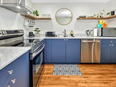 a kitchen with blue cabinets and a sink at Renovated Suite in WL, 5 Min to Downtown, All New Appliances, Self Check-In in Williams Lake