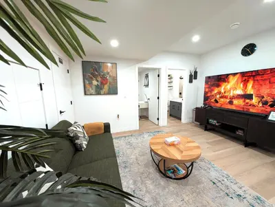 a living room with a couch and a fireplace at Luxury Guest Suite in Calgary in Calgary