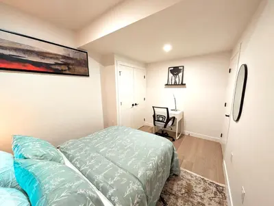 a bedroom with a bed and a desk in it at Luxury Guest Suite in Calgary in Calgary